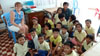 Jenny with the Primary 1 (Grades 1-3) class and their teacher, Phin.